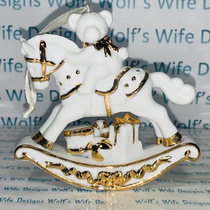 White and gold accents porcelain Christmas ornament Christmas bear on rocking horse decorated with gold accents with gifts underneath