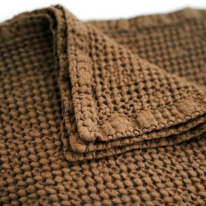 May include: A brown waffle weave throw blanket with a textured surface.