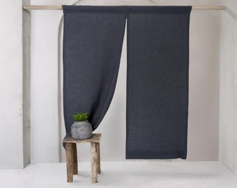Puede incluir: Un par de cortinas de lino gris oscuro colgando de una barra de madera. Las cortinas están reunidas en la parte superior y cuelgan rectas. Una pequeña planta en maceta se encuentra sobre un taburete de madera delante de las cortinas.