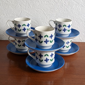 May include: Set of six blue and white floral teacups and saucers. The cups and saucers are stacked on top of each other.