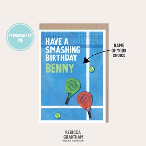 May include: A birthday card with a blue tennis court design. The card features the text "Have a Smashing Birthday Benny" in white and green. Two tennis rackets, one green and one red, are depicted, along with tennis balls.