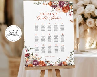 May include: A white seating chart sign for a bridal shower featuring the text "OLIVIA'S Bridal Shower" and "AUGUST 29, 20XX". The design includes floral arrangements in shades of burgundy, orange, and cream at the top and bottom corners.
