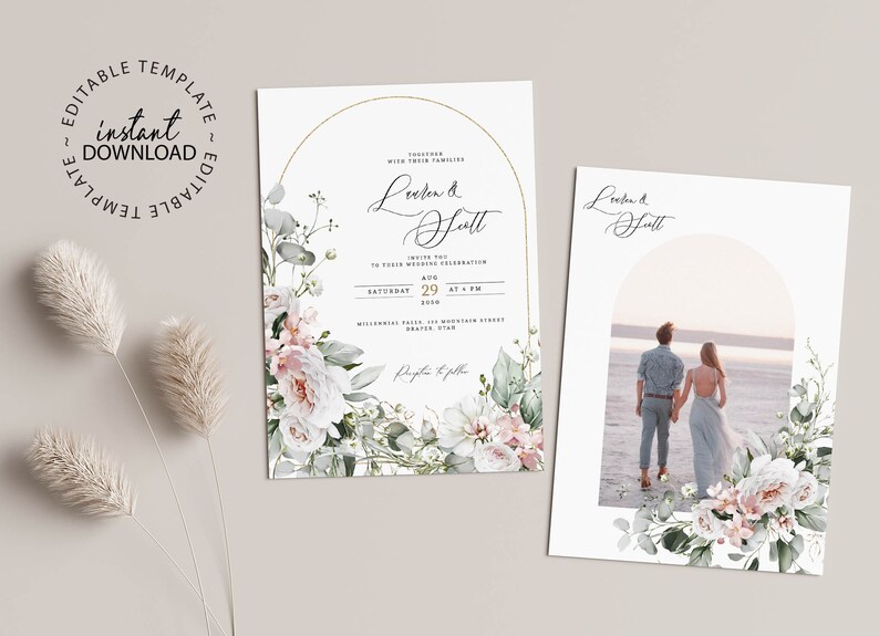 May include: Two wedding invitations with a floral design. The first invitation features a white and green floral wreath with a gold arch and the text "Lorien & Scott". The second invitation features a photo of a couple standing on a beach with a white and green floral wreath around the photo.