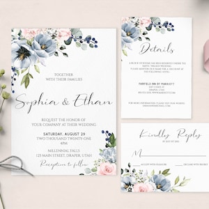 May include: A wedding invitation suite with a floral design featuring blue and pink flowers. The invitation includes the names "Sophia & Ethan", the wedding date, time, and location. The RSVP card includes the text "Kindly Reply by July 1st, 2021".