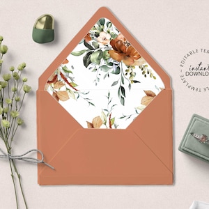 May include: A peach-colored envelope with a white liner featuring a floral pattern in shades of green, brown, and orange. The text "instant download" is printed in black on a white circle with the words "editable template" repeated around the circle.