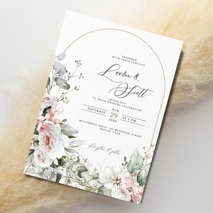 May include: A wedding invitation with a floral design. The invitation is white with gold accents and features a floral wreath with pink and white flowers. The text on the invitation reads "Together with their families, Lauren & Scott, Invite you to their wedding celebration, Saturday, Aug 29, 2056, at 4 PM, Millennial Falls, 123 Mountain Street, Draper, Utah, RSVP to follow".