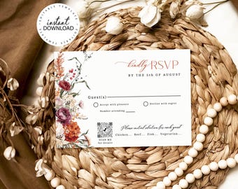 May include: A white RSVP card featuring a floral arrangement on the left side with red, orange, and cream flowers. The text reads kindly RSVP BY THE 5TH OF AUGUST, Guest(s), Accept with pleasure, Decline with regret, and a QR code with SCAN ME.