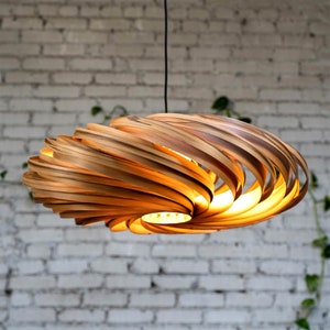 Large hanging lamp made of amber tree wood. Handmade wooden lamp from Cologne studio.