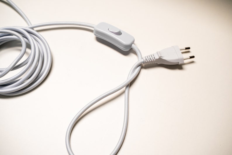 May include: White electrical cord with a white inline switch and a white three-prong plug.