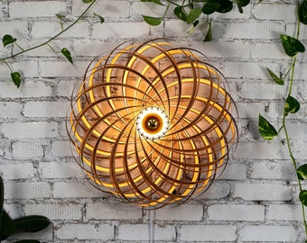 Designer wall lamp made of satin walnut wood. Handmade wooden lamp from Cologne studio.