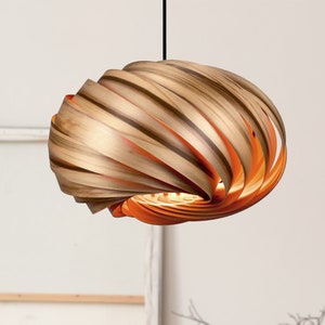 Handcrafted hanging lamp made of spiral-shaped real wood slats. Noble and characterful amber tree with great grain