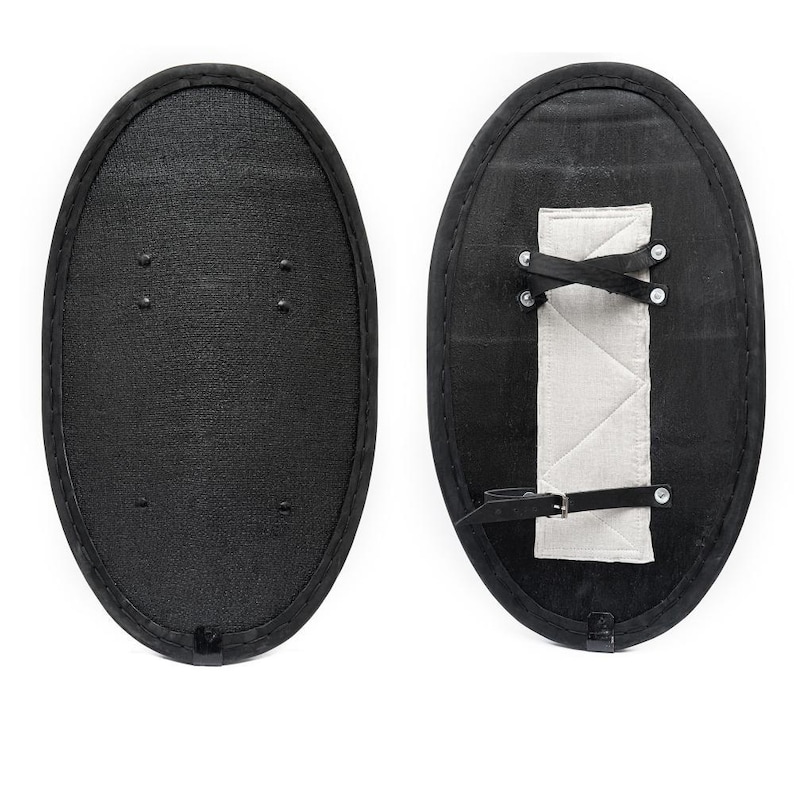 May include: A black oval shield with a leather strap and a white padded handle on the back.