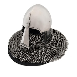 May include: A silver helmet with a pointed nose guard and a chainmail neck guard. The helmet is made of metal and has a smooth, polished finish.
