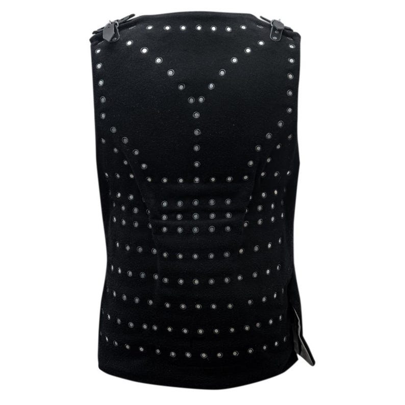 May include: Black sleeveless vest with a pattern of small silver eyelets.