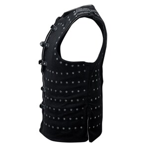 May include: A black sleeveless vest with multiple straps and a pattern of small silver dots.