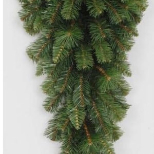 May include: A green artificial pine garland, perfect for decorating a door or mantel for the holidays.