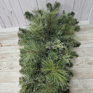 May include: A bunch of green pine branches, perfect for adding a touch of nature to your home decor.
