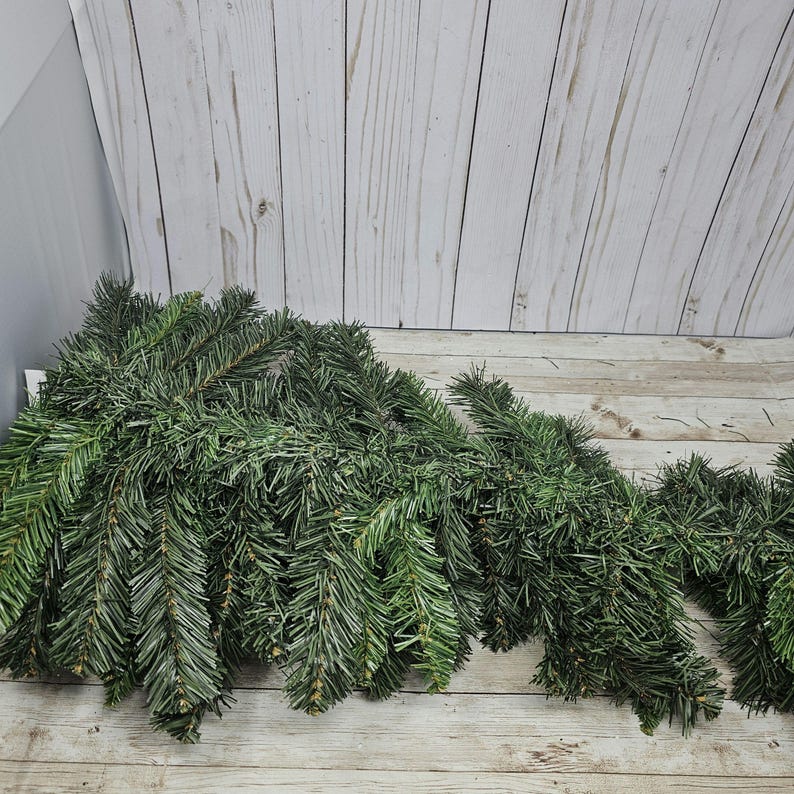 May include: A pile of green artificial pine branches, perfect for crafting or decorating.