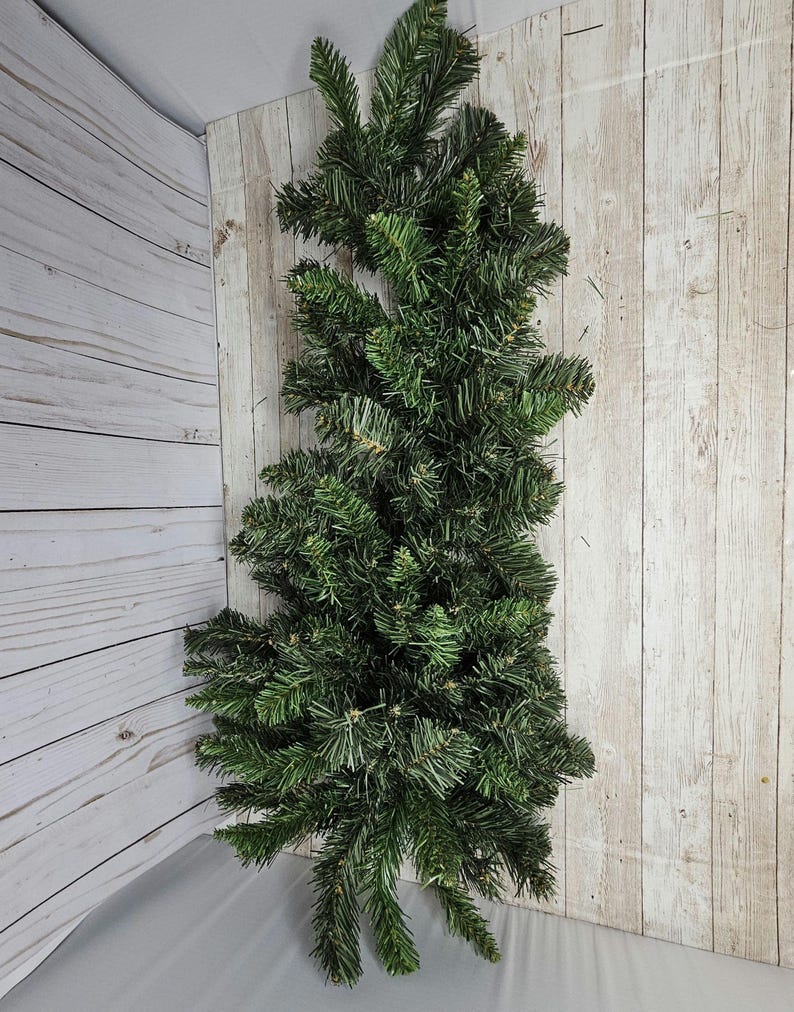 May include: A long, green artificial pine garland with lush, full branches. The garland is perfect for adding a touch of greenery to your home decor.