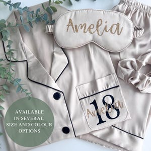 Champagne coloured milestone birthday pyjamas printed for an 18th birthday with both age and name on the pocket complete with matching sleep mask and scrunchie, a truly beautiful luxury set.
