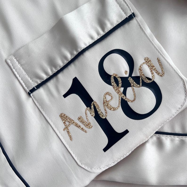 Champagne coloured milestone birthday pyjamas printed for an 18th birthday with both age and name on the pocket complete with matching sleep mask and scrunchie, a truly beautiful luxury set.