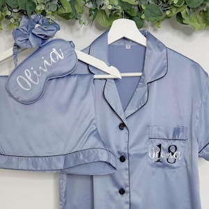 Dusty Blue coloured milestone birthday pyjamas printed for an 18th birthday with both age and name on the pocket complete with matching sleep mask and scrunchie, a truly beautiful luxury set.