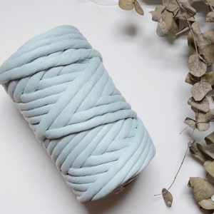 May include: A roll of light blue chunky yarn, ideal for knitting or crocheting.
