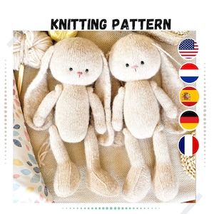 May include: Knitting pattern for two beige bunny plushies with long ears. The bunnies are sitting on a beige fabric background.