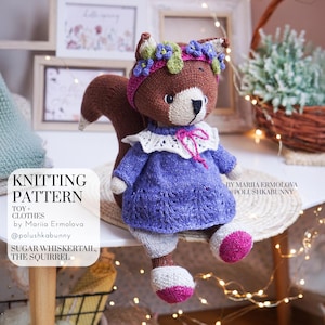 May include: A knitted squirrel toy wearing a purple dress with a white lace collar, a pink headband with purple and green flowers, and white shoes with pink accents. The text on the image reads: KNITTING PATTERN TOY + CLOTHES by Mariia Ermolova @polushkabunny SUGAR WHISKERTAIL, THE SQUIRREL BY MARIIA ERMOLOVA @POLUSHKABUNNY.