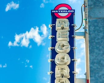 Puede incluir: Un letrero azul y blanco con la palabra "WATERLOO" en un círculo rojo y la palabra "RECORDS" en letras blancas sobre un fondo azul.