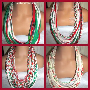 May include: Four braided fabric infinity scarves in a collage. Each scarf is displayed on a mannequin. The scarves feature red, green, white, and patterned fabrics. The center drop is 13-14 inches.