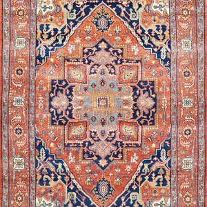 May include: A traditional Persian rug with a red, blue and cream colour scheme. The rug features a central medallion with intricate floral and geometric patterns. The rug has a border with a repeating design.