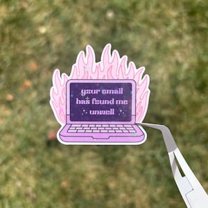 May include: A sticker featuring a purple laptop design with the text "your email has found me unwell" in white. The laptop is surrounded by pink flames. The sticker is being held by tweezers.