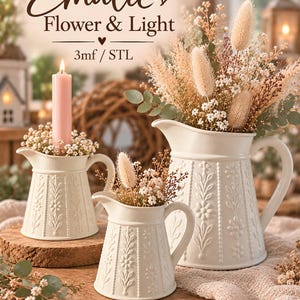 May include: Three off-white ceramic pitchers with embossed floral patterns and vertical beaded lines. The pitchers contain dried grasses and small white flowers. One pitcher holds a tall pink candle. Text reads Emalie Flower & Light 3mf / STL.