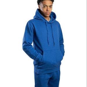 May include: A royal blue hooded sweatshirt and matching sweatpants. The sweatshirt has a pouch pocket and a drawstring hood.