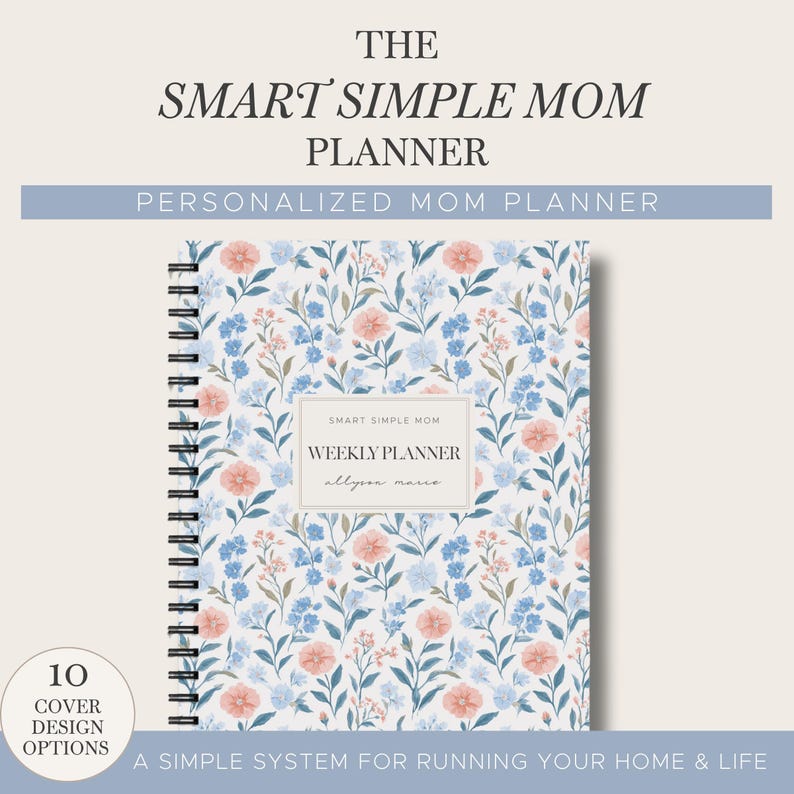 May include: A spiral-bound weekly planner with a white cover featuring a floral pattern of blue and peach flowers. The center label reads "SMART SIMPLE MOM WEEKLY PLANNER allyson marie". The top text reads "THE SMART SIMPLE MOM PLANNER".