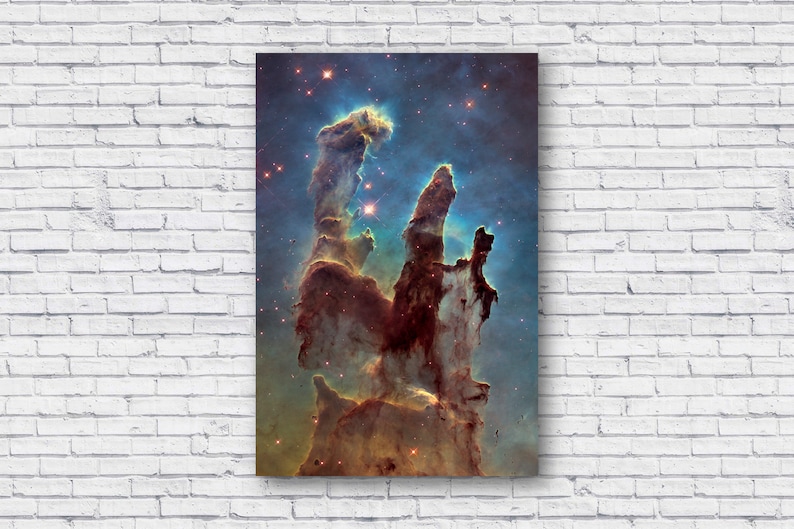 May include: A vibrant, colorful nebula with tall, pillar-like structures of gas and dust. The nebula is a mix of red, orange, yellow, and blue hues, with a bright white star at the center. The background is a dark blue with scattered stars.