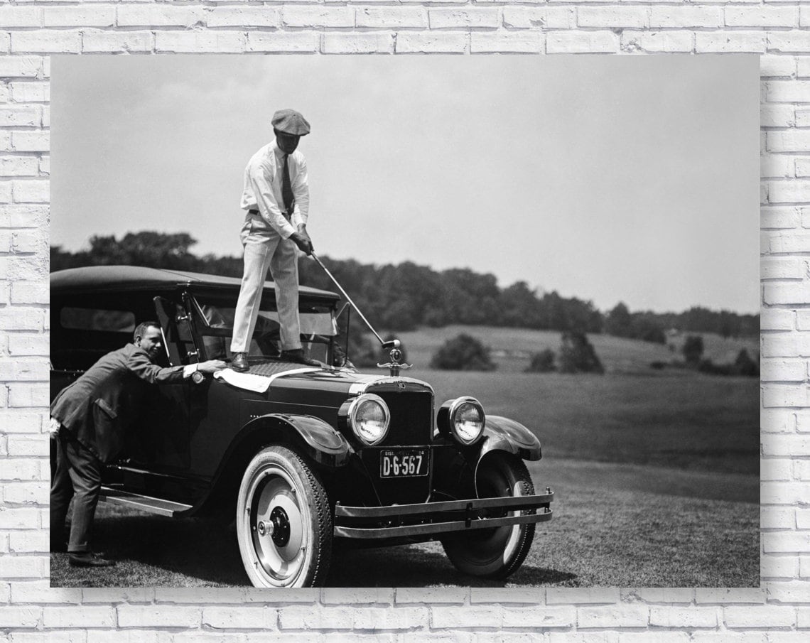 Golfing on a Car Poster Print, 1924 Man hitting Golf Ball off Old Antique Model T Car, Black and White Photograph Wall Art Home Decor