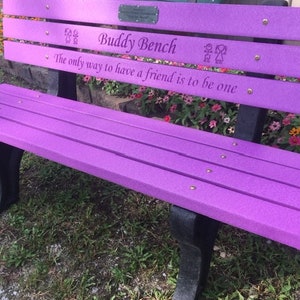 May include: Purple wooden bench with the words "Buddy Bench" and the quote "The only way to have a friend is to be one" engraved on the top.
