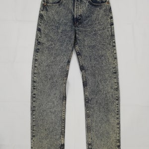 May include: A pair of light blue acid wash jeans with a straight leg fit.