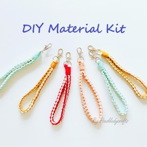 May include: A collection of colorful DIY material kits for wrist lanyards. The lanyards are in various colors, including red, orange, yellow, and blue, with silver-colored clasps. The text "DIY Material Kit" is in blue script.