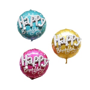 May include: Three round foil balloons in teal, gold, and pink. Each balloon has the words "Happy Birthday" in white script. The teal balloon has white star accents, and the pink balloon has white polka dots. The gold balloon is plain.
