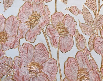 May include: Pink and gold floral fabric with a raised texture. The fabric features a repeating pattern of pink flowers with gold outlines and leaves.