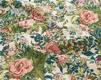 May include: A close-up of a fabric with a floral pattern. The fabric is a cream color with a green and pink floral design. The flowers are roses and other small flowers.