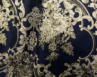 May include: A navy blue fabric with a gold and green damask pattern. The pattern features intricate floral and scroll designs.