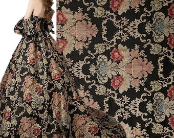 May include: Black fabric with a gold and red floral damask pattern. The fabric is woven with a raised texture.