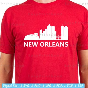 May include: A red t-shirt with a white silhouette of the New Orleans skyline, including the Superdome and the French Quarter. The text "NEW ORLEANS" is printed below the skyline.