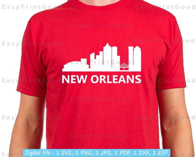 May include: A red t-shirt with a white silhouette of the New Orleans skyline, including the Superdome and the French Quarter. The text "NEW ORLEANS" is printed below the skyline.