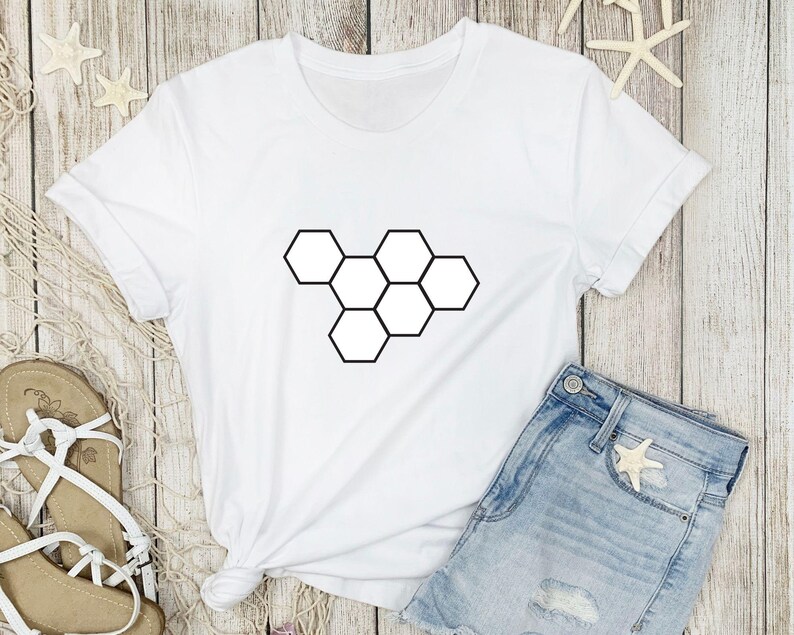 May include: White t-shirt with a black geometric honeycomb design.