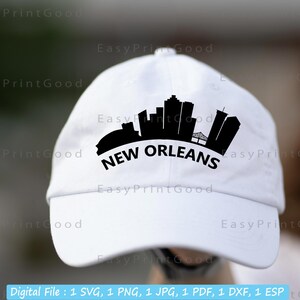 May include: White baseball cap with a black silhouette of the New Orleans skyline and the text "NEW ORLEANS" in black.